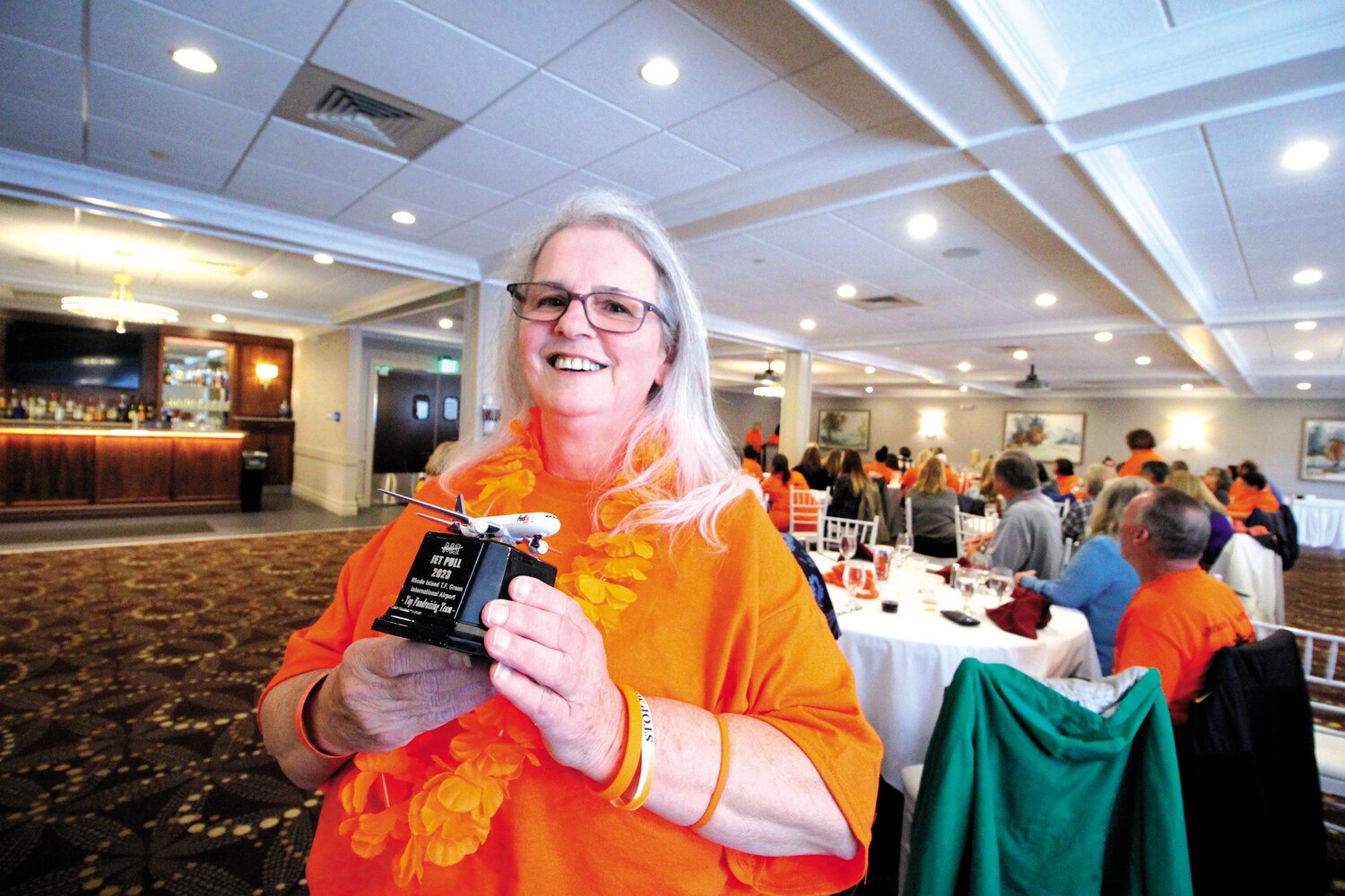 TEAM LEADER: Retired Warwick teacher Joan Wilkinson as pictured Saturday at the retirement party hosted her by fellow Holliman School teachers and friends at Chelo’s. She is holding the award the Wilkinson Warriors won for raising the most donations in the MS Jet Pull.